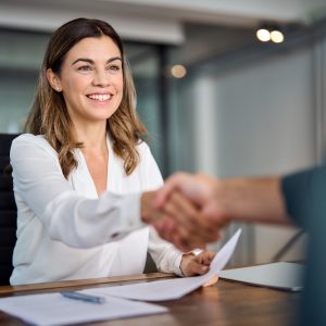 Happy,Mid,Aged,Business,Woman,Manager,Handshake,At,Office,Meeting.